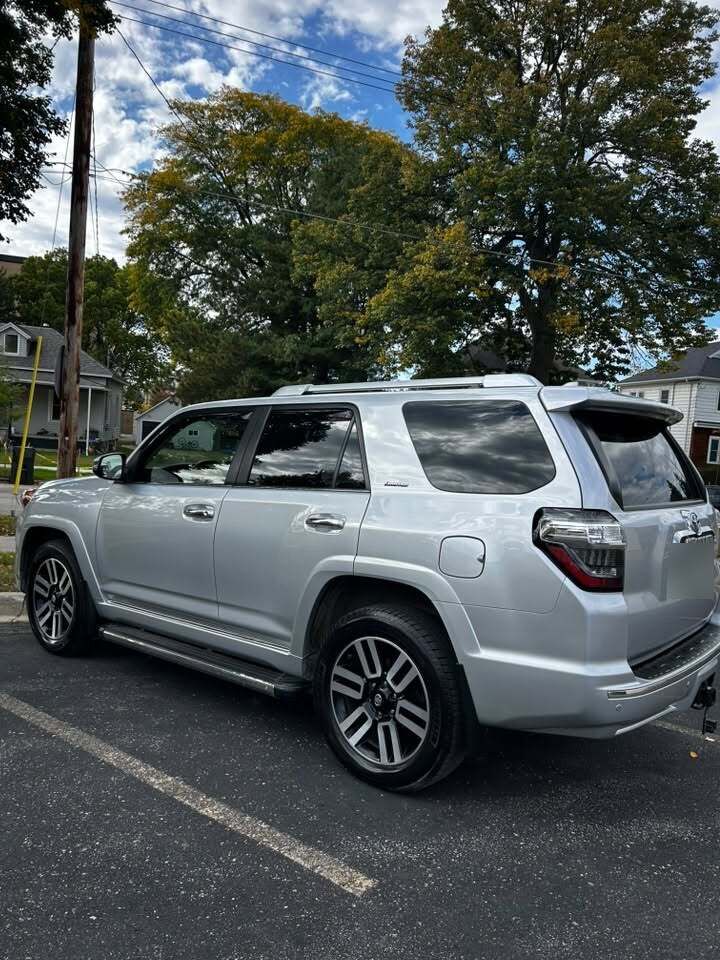 Silver Toyota 4Runner, freshly detailed, under a blue sky